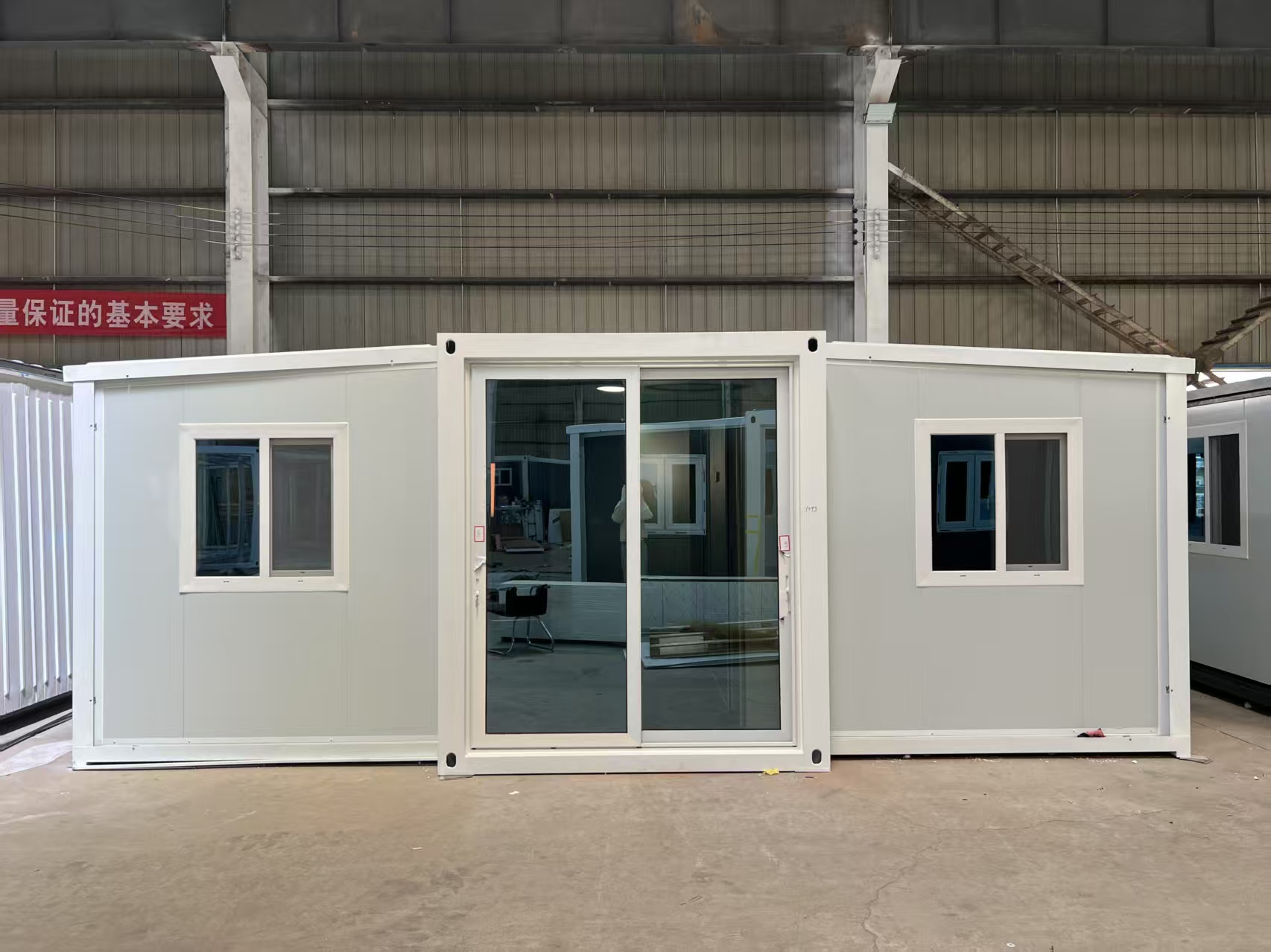 Expandable container house front view with doors and windows
