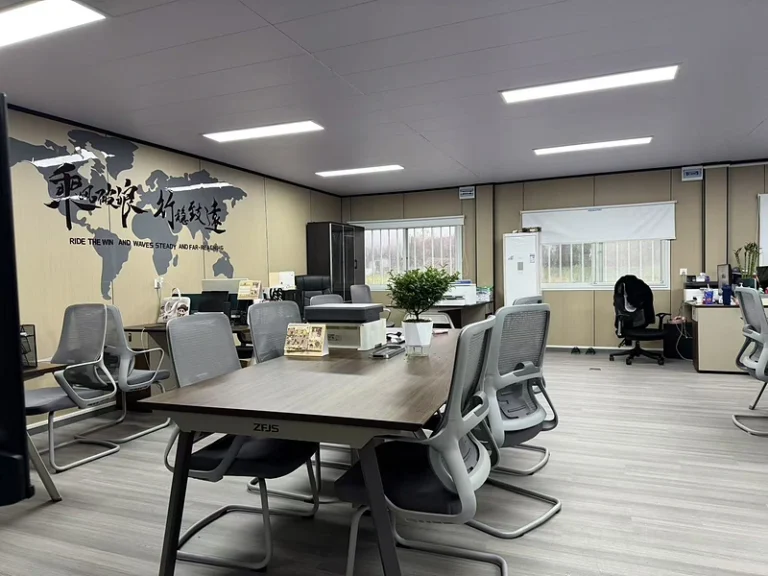 Interior office space inside a modular building with meeting table and chairs