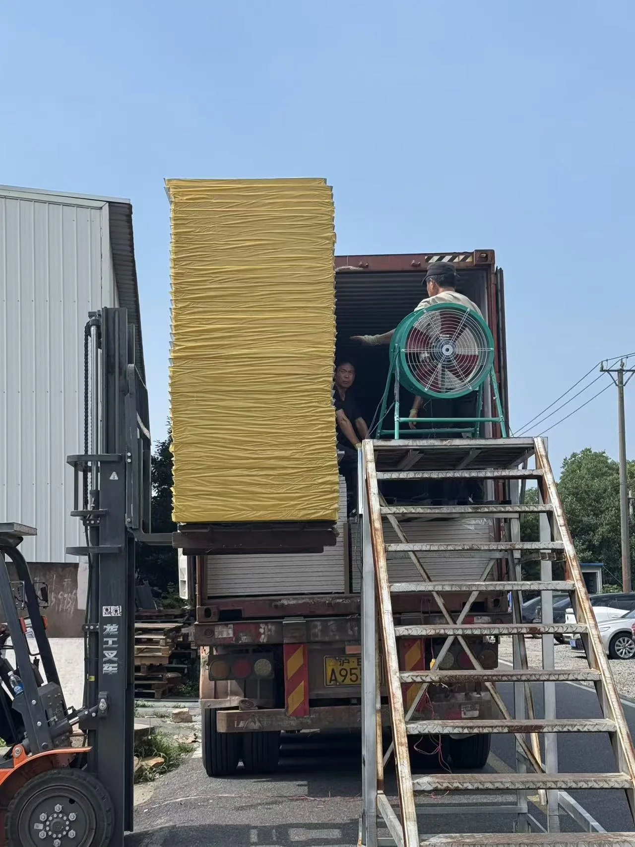 How Many Container Houses Fit in a 40HQ? A Practical Shipping Guide factory loading flat pack container house panels into a 40HQ container